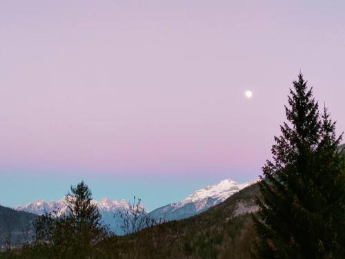 a view of a mountain range with snow capped mountains at Il Terrazzo Sulle Dolomiti in Cibiana