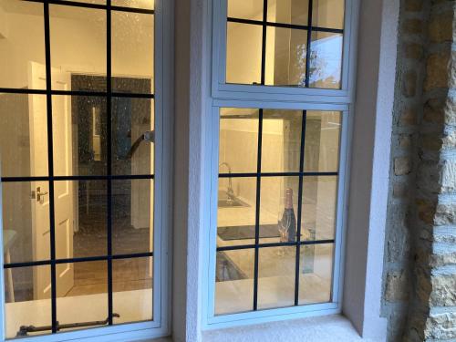 two windows in a house with black and white at Yew Tree House in Woodstock