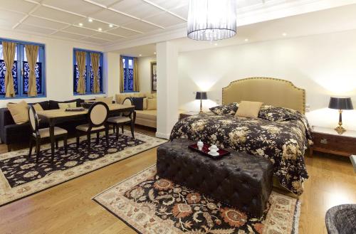 a bedroom with a bed and a dining room at Zagori Suites Luxury Residences in Vitsa