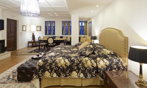 a bedroom with a bed and a dining room at Zagori Suites Luxury Residences in Vitsa