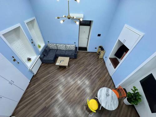 a living room with a couch and a table at Turquoise Apartment in Baku