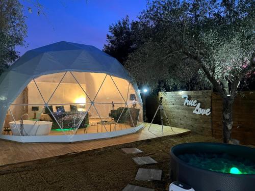 a dome tent in a yard at night at Bubble Glamping Sicily in Catania