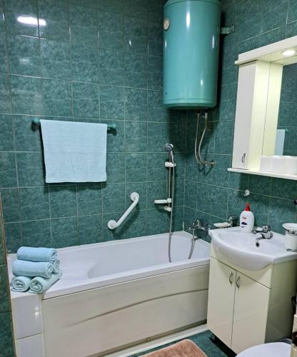 a bathroom with a tub and a sink at A First class za 4 osobe 2 spavaće sobe in Tuzla