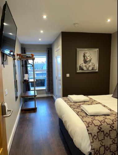a hotel room with a bed and a ladder at The Vine Hotel Chapel st Leonards in Skegness