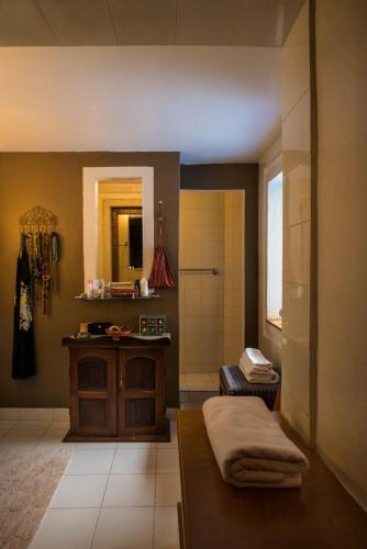 a bathroom with a shower and a sink and a mirror at Casa Britona in Panaji