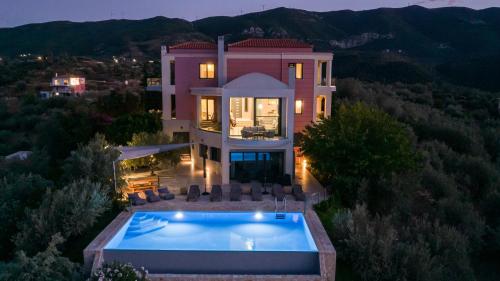 an aerial view of a house with a swimming pool at Saronic TopView Villa in Galatas