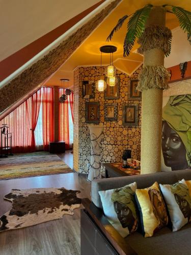 a living room with a couch and two columns at Панівецька Садиба in Zubrivka