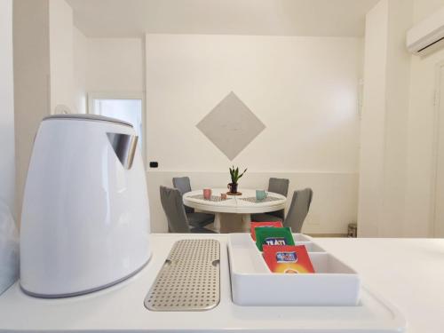 a white blender sitting on a counter next to a table at My Suite Fiuggi in Fiuggi