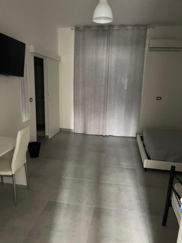 an empty room with a bed and a window at B&B UN POSTO AL MARE San Salvo Marina in San Salvo