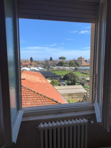 an open window with a view of a roof at Casa Viola vicino al mare by SMART-HOME in Vallecrosia