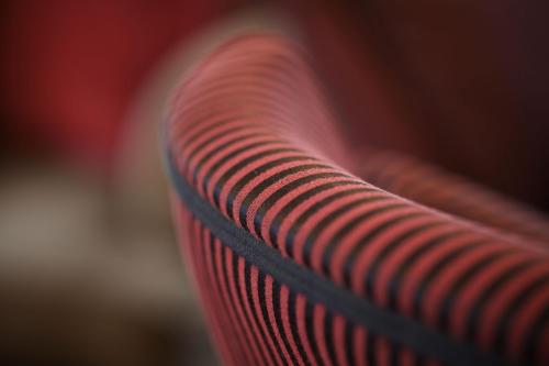 a close up of the back of a red bench at Zagori Suites Luxury Residences in Vitsa