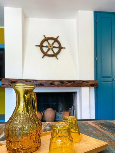 three yellow glass vases sitting on a wooden table at Villa con grande giardino ad 800 mt dal mare in Capitana