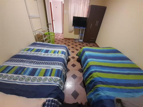 Cama o camas de una habitación en Hostal MIRAMAR En Pleno Centro de Pozo Almonte