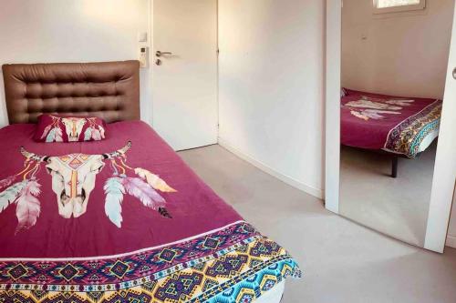 a bedroom with a bed with a cow head on it at Villa bord de mer in Le Grau-dʼAgde