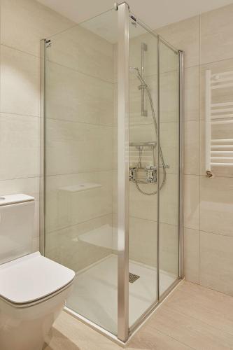 a shower stall in a bathroom with a toilet at ATeRIAN GAZTELU in Zarautz