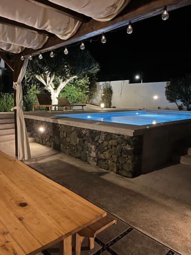 a pool table in a backyard at night at Casa Às Sete in Angra do Heroísmo