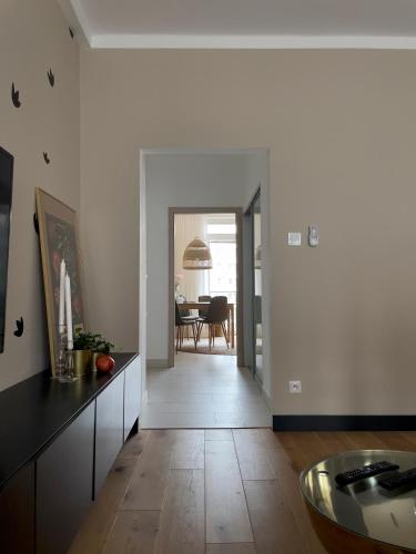 a living room with a kitchen and a dining room at Sweet Home by Zoom Apartments in Nivy