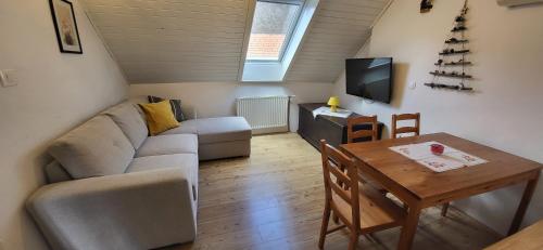 a living room with a couch and a table at Apartments & Hostel Bohinj in Bohinj