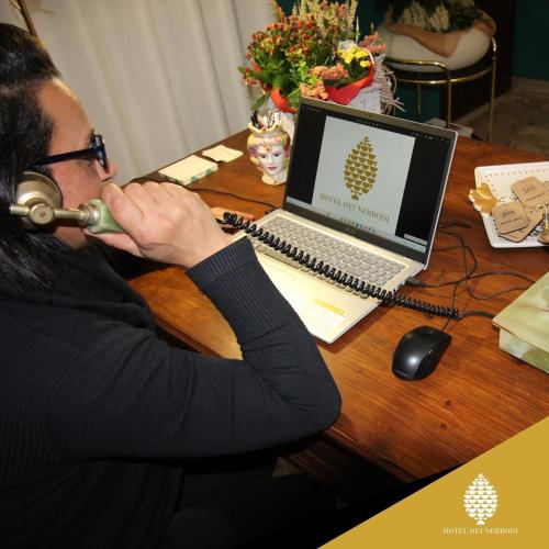 a man playing a trumpet in front of a laptop computer at Hotel dei Nebrodi in Cesarò