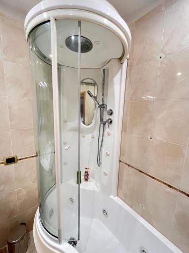 a shower with a glass door in a bathroom at Santa Maria Home in Naples