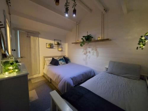 a bedroom with two beds and a window at Seafield Cabin in Tromra