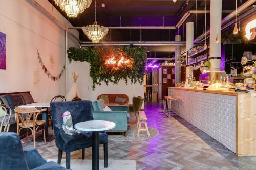 a restaurant with chairs and tables and a bar at ClinkMama in Amsterdam