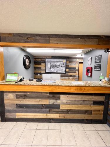 a lobby with a counter made out of wood at Super 8 by Wyndham Humboldt in Humboldt
