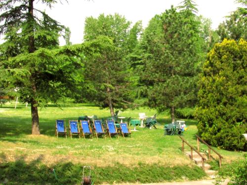 a group of chairs and tables in a park at Park Hotel Salice Terme - OltrePò Pavese - in Salice Terme