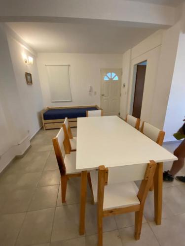 a white table and chairs in a room at Muy lindo departamento! in Puerto Madryn