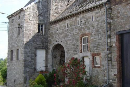 an old brick building with two white garage doors at Relaxing Villa with Pool in Filot