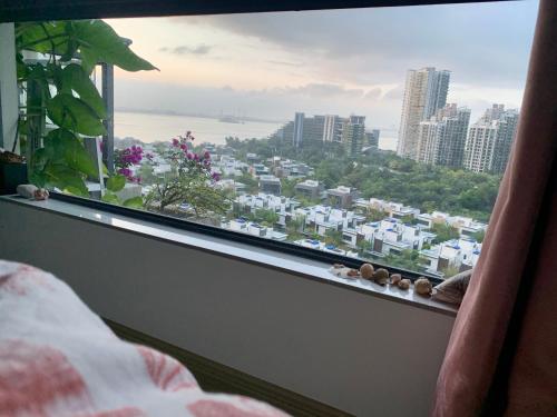 a bedroom window with a view of a city at Sea view 2 bedroom Fully furnished Apartment Forest City Starview Bay Johor Malaysia in Kampong Pok Kechil