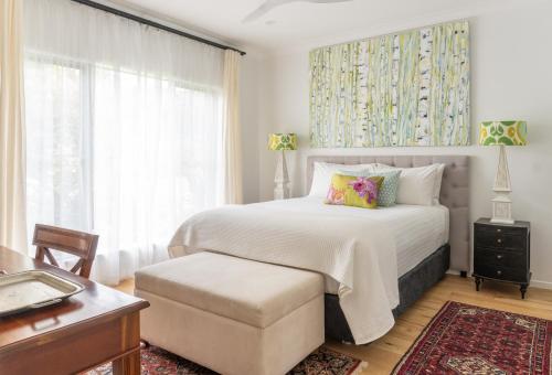a bedroom with a large bed and a window at Byron Studio Apartment in Suffolk Park