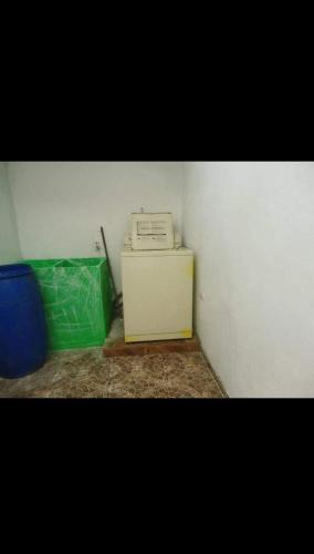 a corner of a room with a fax machine on a cabinet at Casa el remanso in Acacías