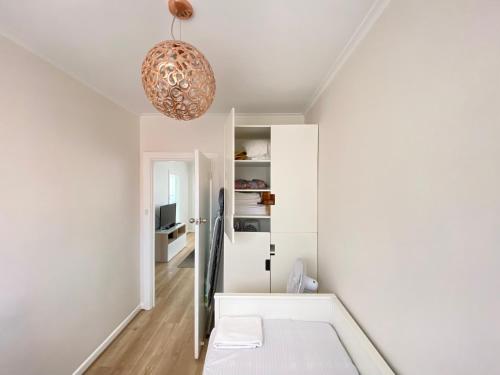 a living room with white walls and a ceiling at Glenelg Holiday Apartments-The Broadway in Glenelg