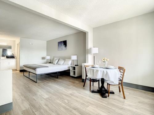 a bedroom with a bed and a table with chairs at Stayable Kissimmee West in Kissimmee