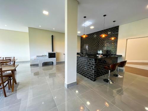 a kitchen and dining room with a table and chairs at Pousadinha Campos in Campos do Jordão