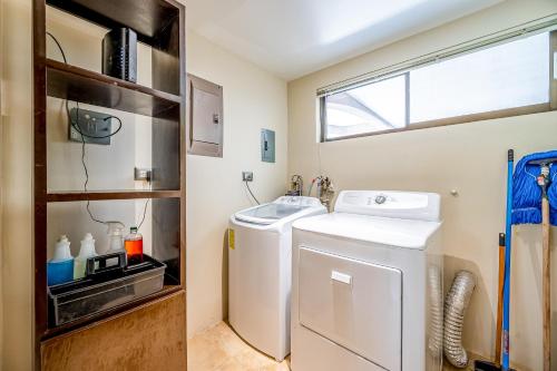 a small laundry room with a washer and dryer at The Cove #15 in Ocotal