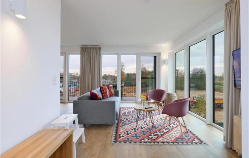 a living room with a couch and a table and chairs at Beach Front Apartment in Lembruch