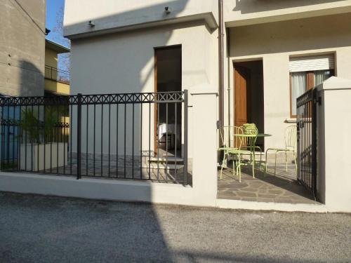 a balcony of a house with a gate and a table at Appartamenti Villa Tonni in Gabicce Mare