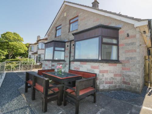 a table and chairs in front of a house at Waters Edge in Stranraer