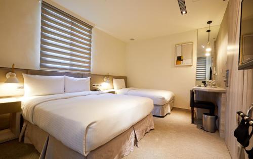 Postel nebo postele na pokoji v ubytování Hai Fu Hotel & Suites
