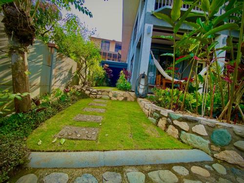 a garden with a stone walkway next to a building at Casa Los Madriz Suite #2 in San Isidro