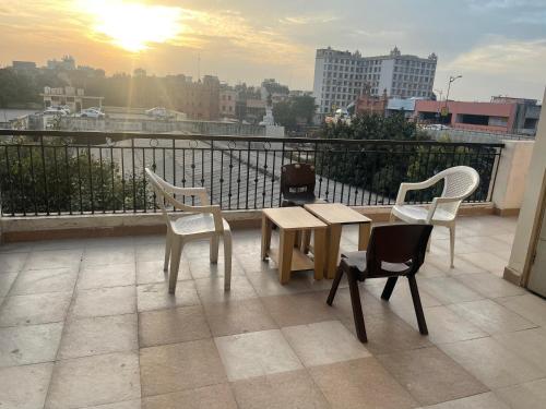 three chairs and a table on a balcony with a view at Siddharth BnB - Near Golden Temple in Amritsar