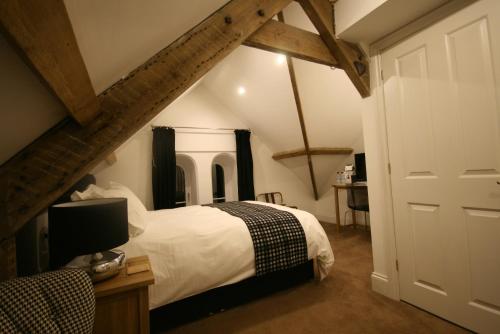a bedroom with a bed and a desk with a tv at Caemorgan Mansion in Cardigan