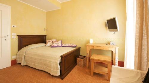a small bedroom with a bed and a television at A Casa Di Paola in Chiarano