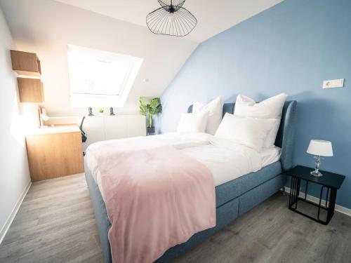 a bedroom with a large bed with white pillows at Noble Suite - Living & Work Place in Gießen