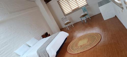 a bedroom with a bed and a wooden floor at Rústic Quinta La Aurora in Baños