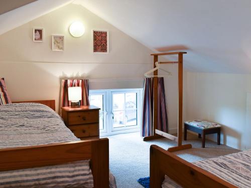 a bedroom with two beds and a window at Dove Cottage in South Hill