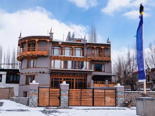 a house with a blue flag in front of it at Dakpa House Ladakh in Ranbirpura