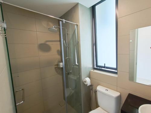 a bathroom with a glass shower and a toilet at Medini Elysia Park , 3 min to Legoland, Netflix By Hint Homestay in Nusajaya